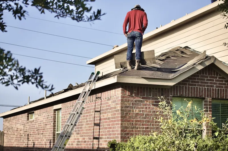 Professional roofer working on a residential roof in Greenville Memorial Hospital